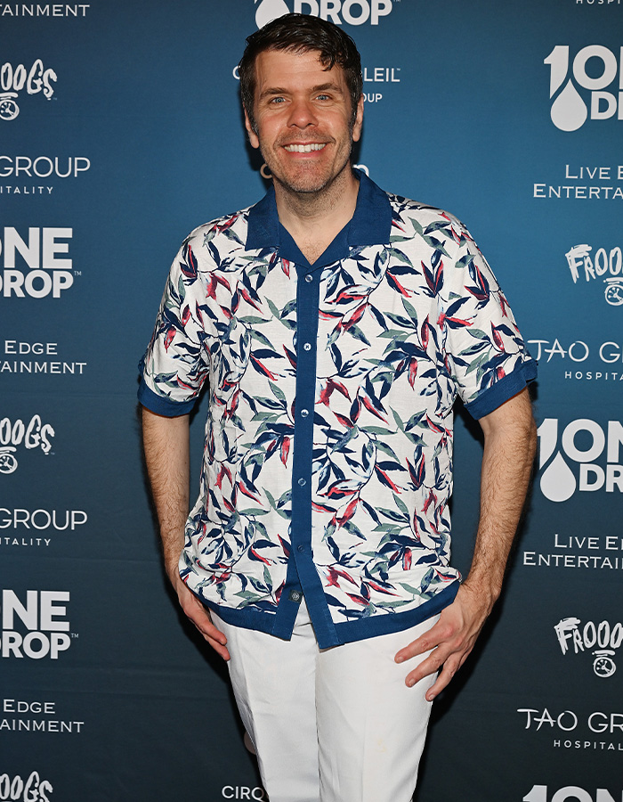 Perez Hilton, smiling at an event, prior to suffering significant injuries and needing surgery. Perez Hilton, smiling at an event, prior to suffering significant injuries and needing surgery.