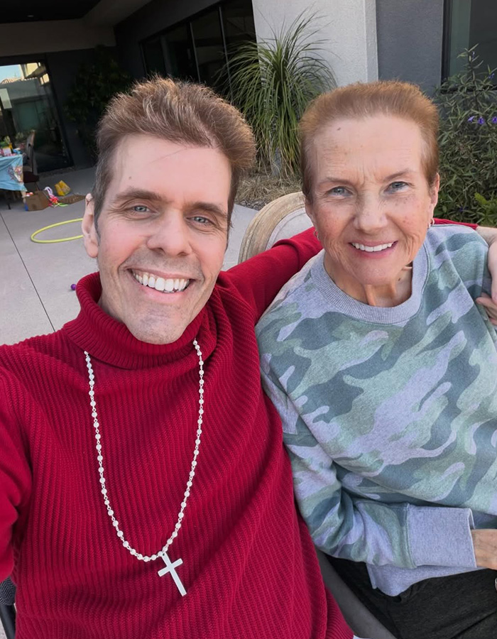 Perez Hilton smiling and taking a selfie with an older woman, both looking happy and healthy, after his injuries. Perez Hilton smiling and taking a selfie with an older woman, both looking happy and healthy, after his injuries.