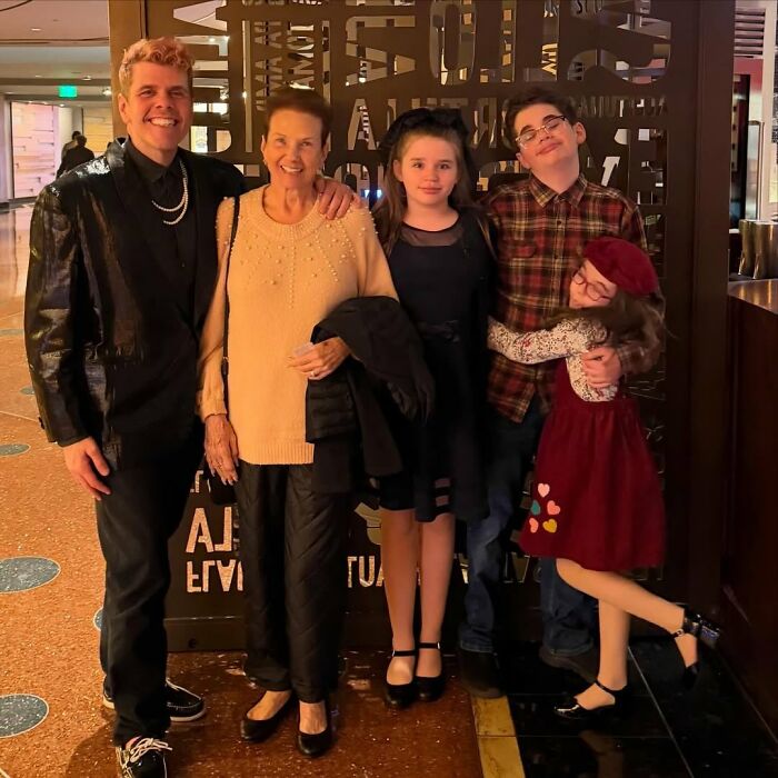 Perez Hilton smiling with family members, including an older woman and three children, related to his crisis. Perez Hilton smiling with family members, including an older woman and three children, related to his crisis.