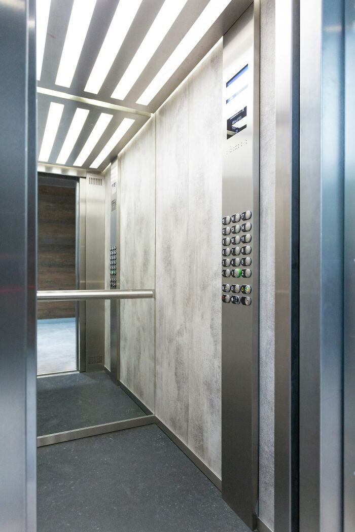 An empty elevator, its doors open, creating a suspenseful atmosphere for creepy true stories.