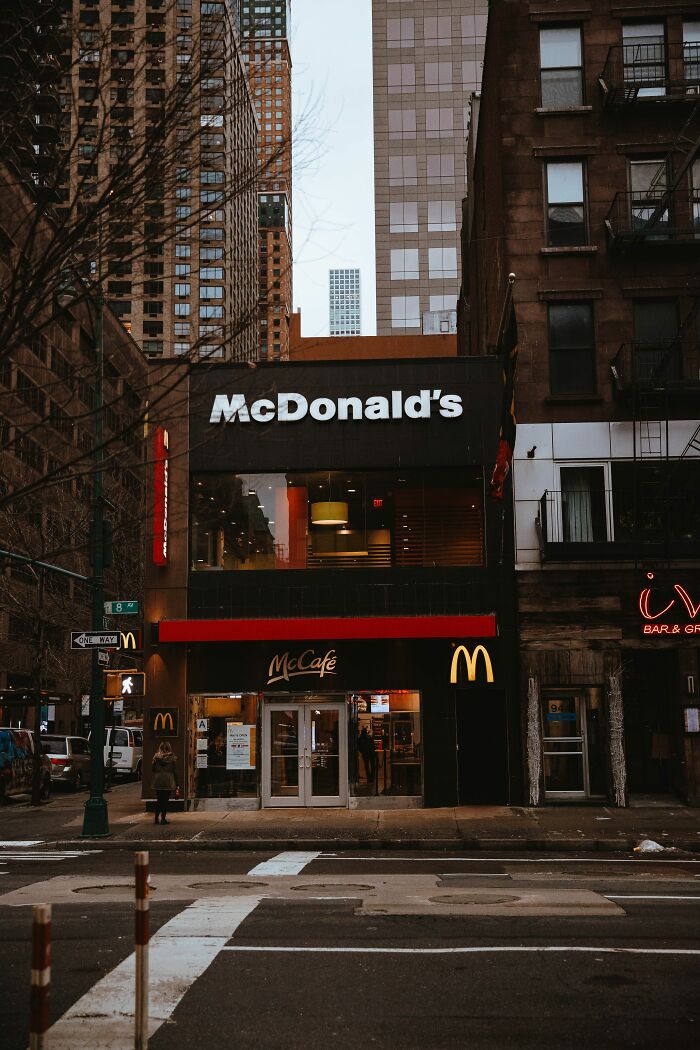 A McDonald's restaurant in an urban setting, representing a common sight newcomers to America might encounter.