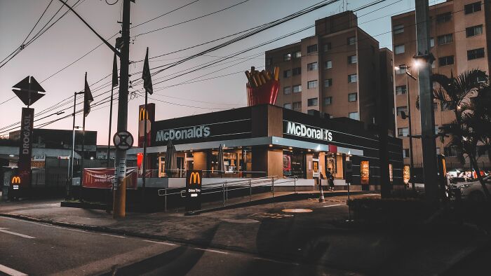 A McDonald's restaurant at dusk, highlighting a popular drive-through location for customers.