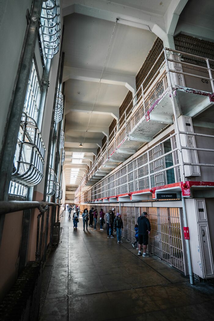 A long hallway inside an old prison with rows of cells, showcasing historical misconceptions.