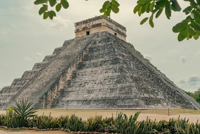The ancient Chichen Itza pyramid under a cloudy sky, a historical site where misconceptions might arise.