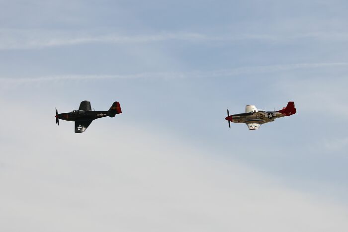 Two vintage planes flying in the sky, illustrating misconceptions about historical aviation or technology.