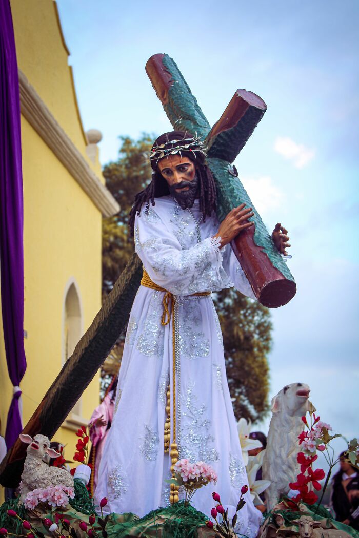 Religious statue of Jesus carrying a cross, symbolizing deeply held beliefs and potential misconceptions.