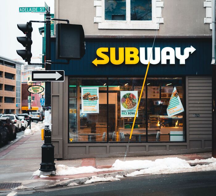 A Subway restaurant on a snowy street, a common workplace where employee stories and HR issues can arise.