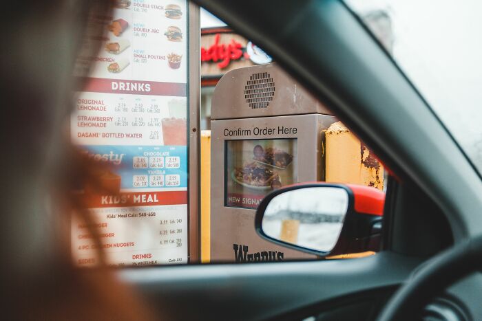 View from inside a car at a Wendy's drive-through menu, with a confirm order screen, crazy things customers said.