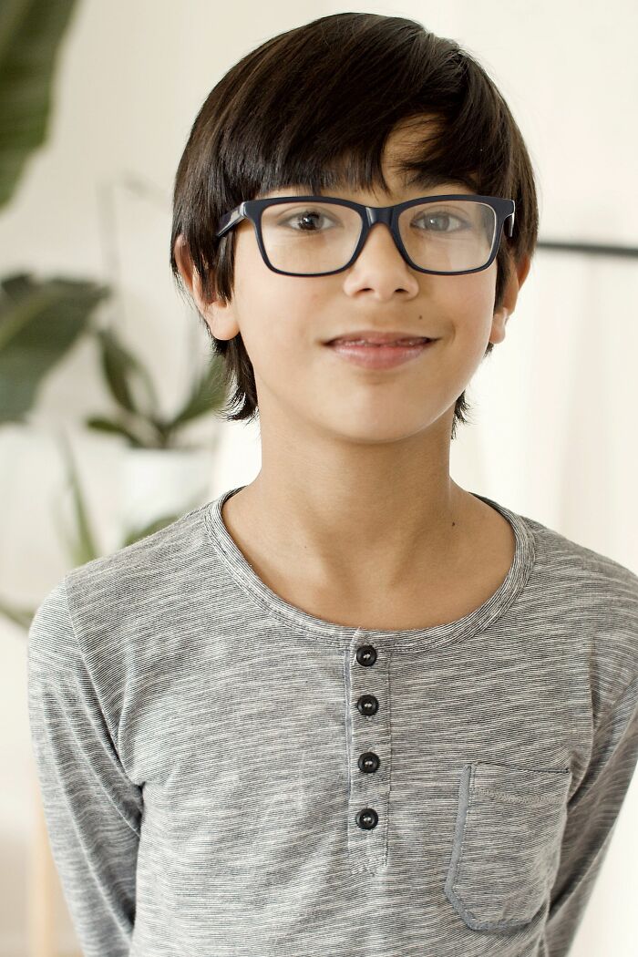 A young boy with glasses, delivering a sick burn.