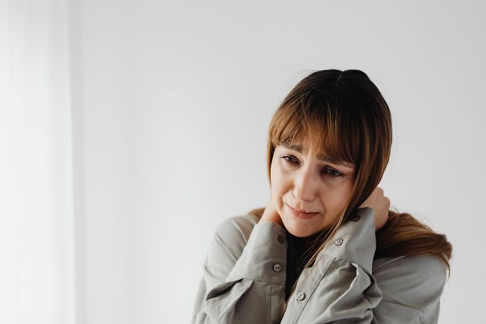 A woman crying, reflecting on a moment her boyfriend said something she could never come back from.