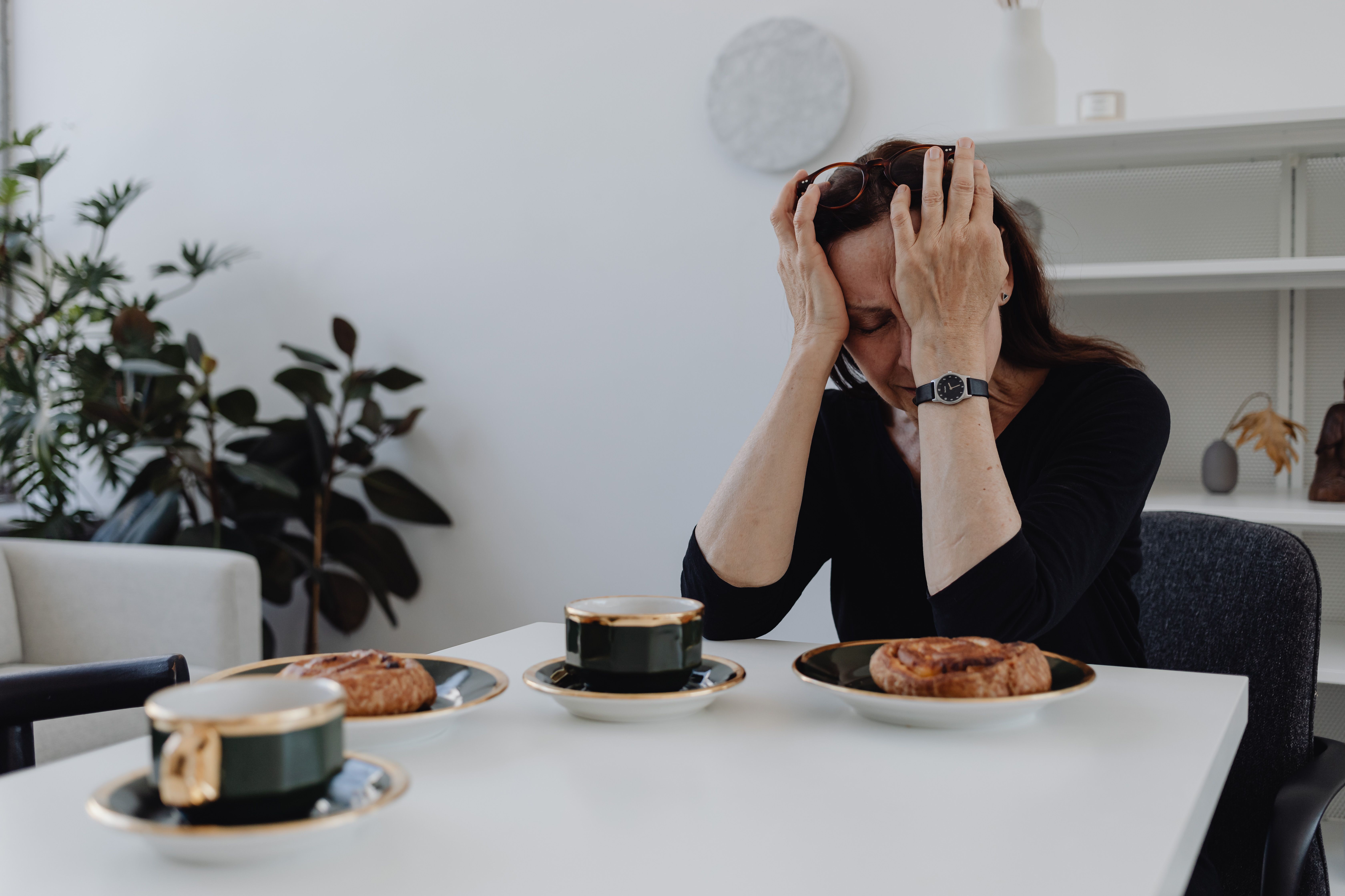 A distressed woman with hands on her head, contemplating a savage ultimatum about her MIL moving into her house. A distressed woman with hands on her head, contemplating a savage ultimatum about her MIL moving into her house.