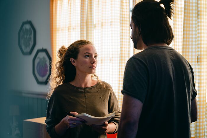 A woman looking intently at her boyfriend, showing the exact moment he said something she could never come back from.