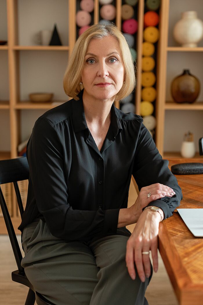 A serious woman at a desk, illustrating incredible accomplishments and motivation in a professional setting.