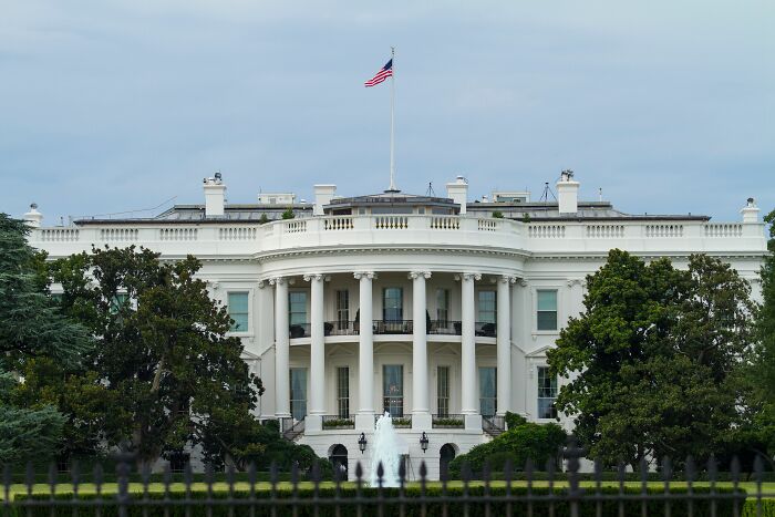 The White House, a symbol of power and the spread of propaganda influencing public opinion and misconceptions.