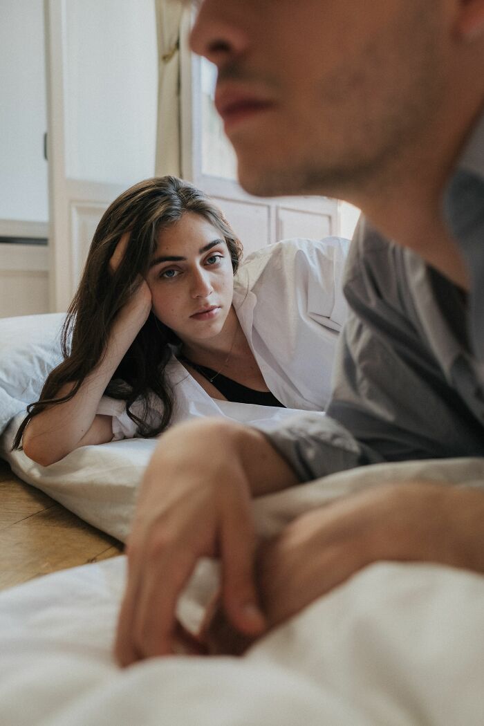 A woman looking at her partner with an expression that shows she realized they’re with the very wrong person.