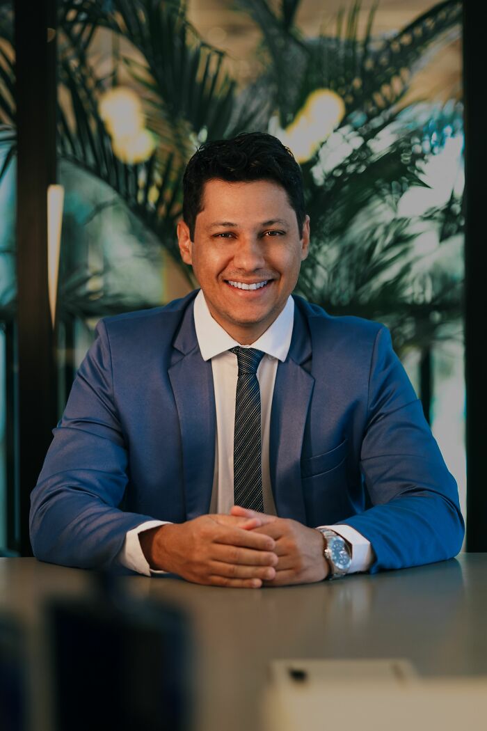 A smiling man in a suit, possibly a coworker sharing personal details or dealing with PTSD.