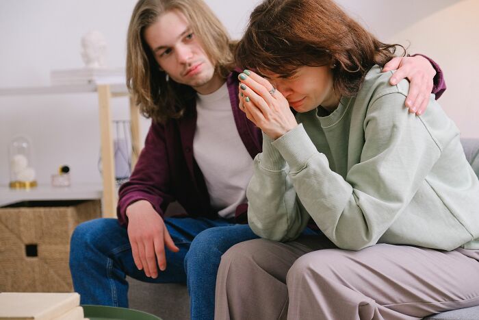 A woman cries as a man comforts her, highlighting a moment with the wrong person.