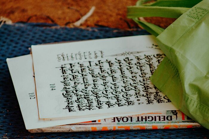 A close-up of a book open to a page with foreign languages script, hinting at testing knowledge of languages. A close-up of a book open to a page with foreign languages script, hinting at testing knowledge of languages.