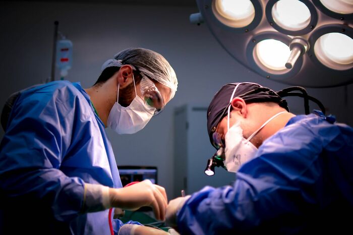 Two medical field workers performing surgery, demonstrating the critical and demanding nature of their profession.