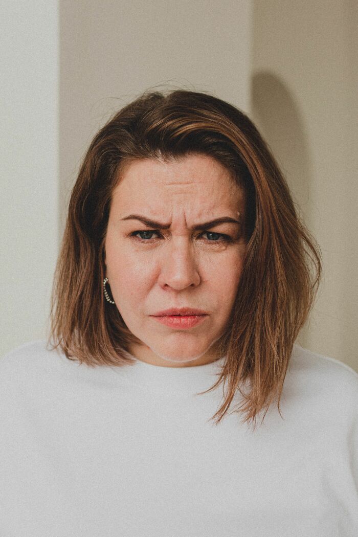 A woman looks frustrated, realizing she's with the wrong person.