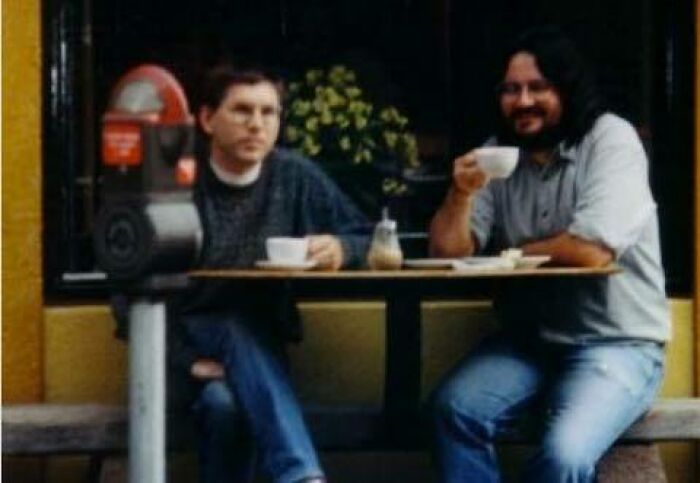 Two men drinking coffee at an outdoor cafe, a funny stats class meme.