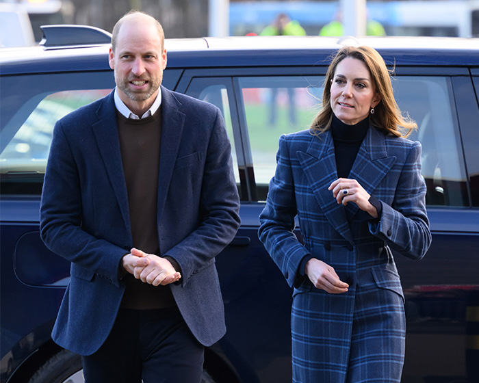 Prince William and Kate Middleton, possibly reacting to a name change demand, standing by a car.