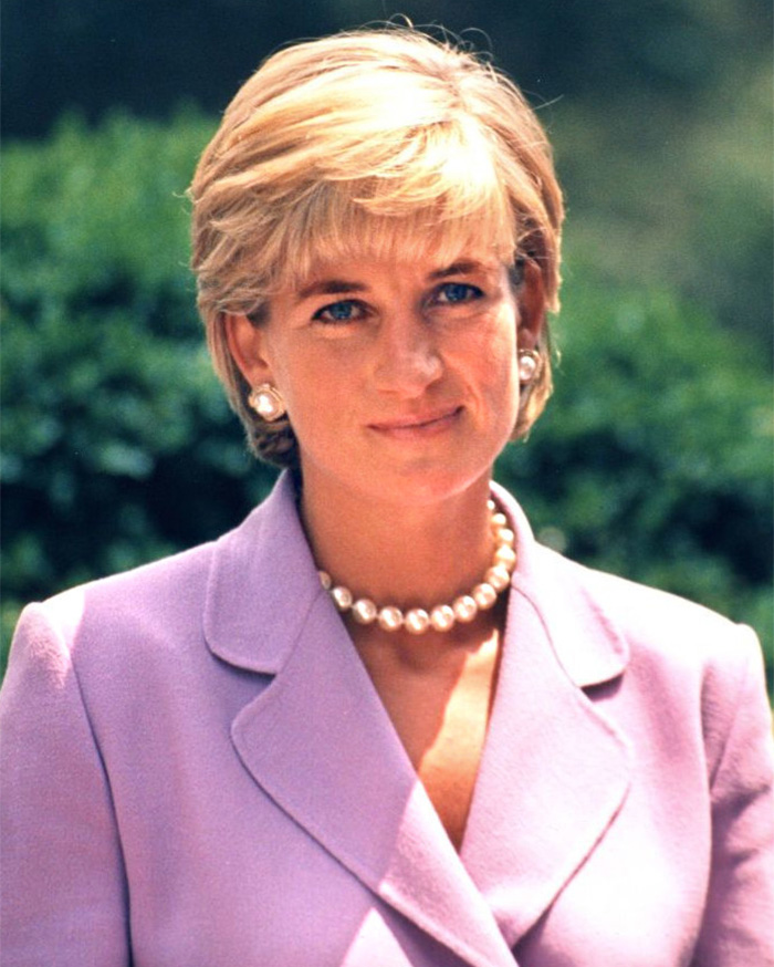 A close-up of Princess Diana, smiling gently, wearing a pearl necklace and earrings. A close-up of Princess Diana, smiling gently, wearing a pearl necklace and earrings.