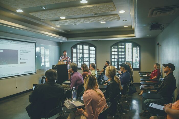 College life: A classroom setting with students listening to a lecture, showcasing the complete freedom of learning in a new world.