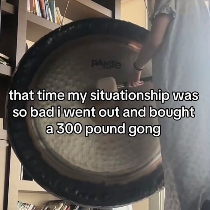 A person standing by a large gong with text overlay, one of the hilarious memes about relationship struggles.