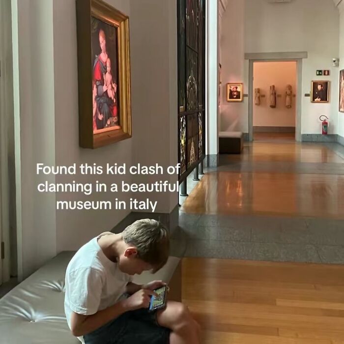 A boy playing Clash of Clans on his phone in an Italian museum, showcasing hilarious memes.