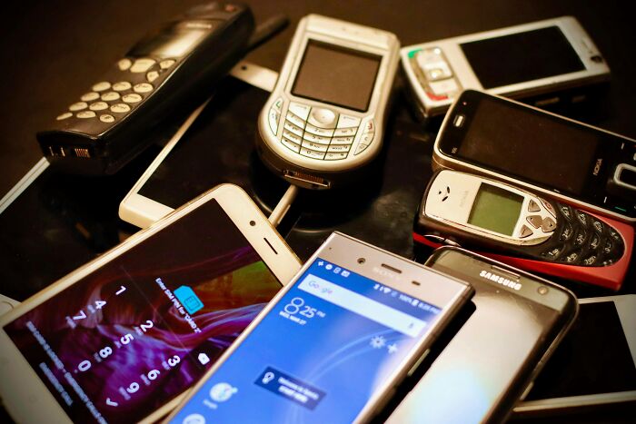 A pile of old and new cell phones, showing how people got rich from technology.