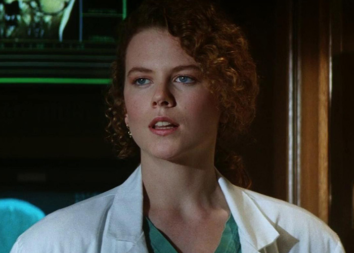 Nicole Kidman with curly hair, wearing a white lab coat as Dr. Claire Lewicki in Days of Thunder. Nicole Kidman with curly hair, wearing a white lab coat as Dr. Claire Lewicki in Days of Thunder.