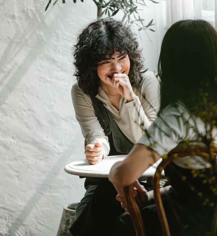 Two women share a laugh, enjoying a close friendship that could fall apart after years.