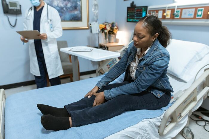 Woman sitting on a hospital bed, thinking about friendships that fell apart after years of being close.