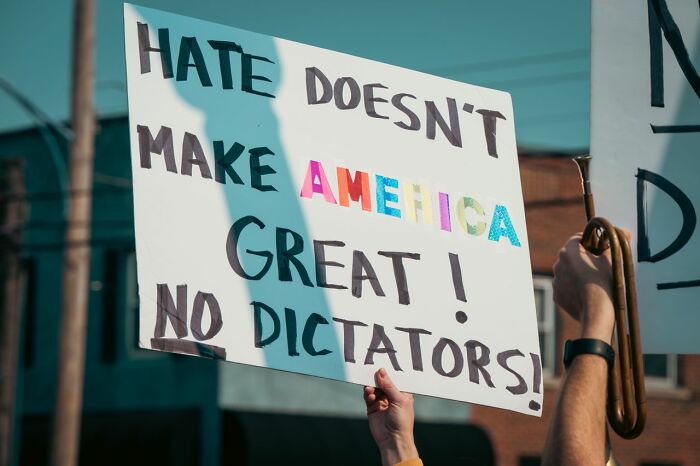 Protest sign saying Hate Doesnt Make America Great, symbolizing friendships that fell apart.