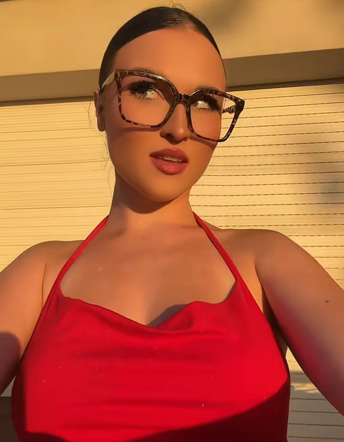 A close-up of a viral Red Bikini Girl posing in a red swimsuit, looking upwards with stylish glasses. A close-up of a viral Red Bikini Girl posing in a red swimsuit, looking upwards with stylish glasses.