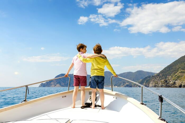 Two boys on a boat, enjoying a moment often associated with the privileged rich.