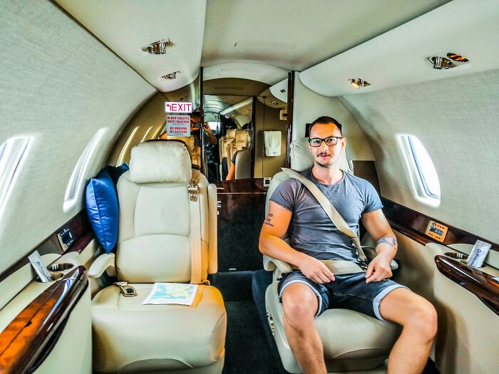 A man on a private jet, embodying the lavish lifestyle and wild moments of the rich.