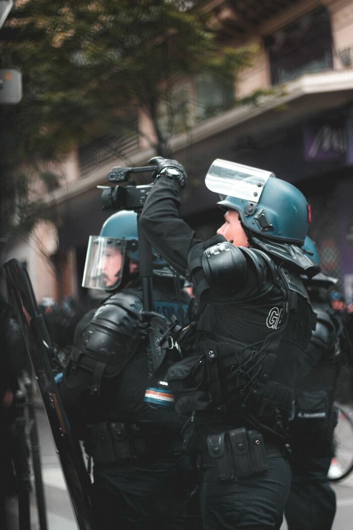 Police officers in riot gear, capturing the intensity of some court case stories.