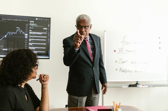 An older man pointing at a seated woman, illustrating the intensity of some court case stories.