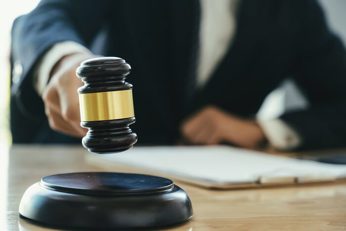 A judge's gavel hitting a sound block during a court case. The image highlights the legal aspect of court case stories.