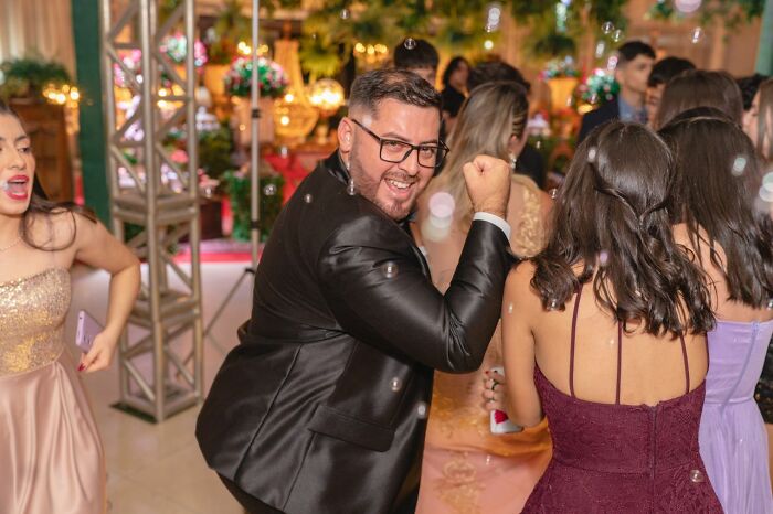 A man in a suit dancing at a party. This image could represent a ridiculous court case story involving a social event.