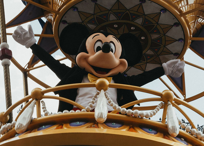 Mickey Mouse on a parade float, a childlike indulgence that could be a manifestation of a midlife crisis.