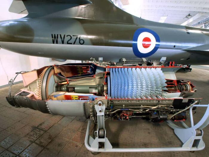 Interesting and surprising photo of an airplane jet engine cut in half, showing internal components.