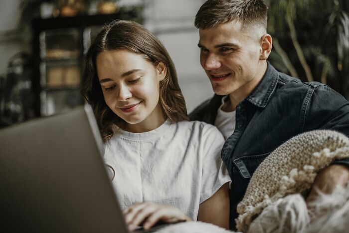 A couple looking at a laptop, possibly searching for a common name that is hard to pronounce. A couple looking at a laptop, possibly searching for a common name that is hard to pronounce.