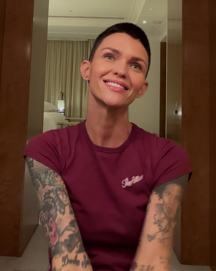 Ruby Rose smiles, showing her extensive arm tattoos, in a close-up photo. Ruby Rose smiles, showing her extensive arm tattoos, in a close-up photo.