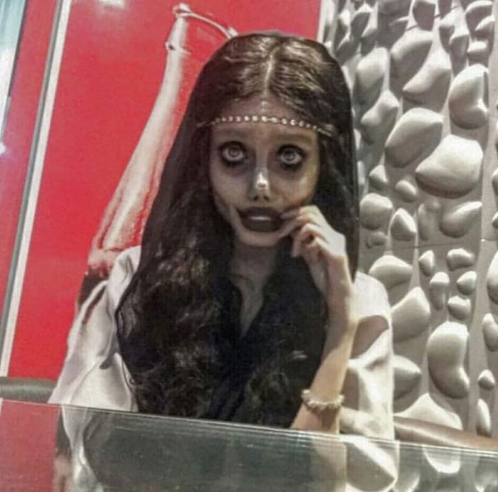 Iranian woman, the Zombie Angelina Jolie, with dark hair, looking ghostly, part of the illusion.