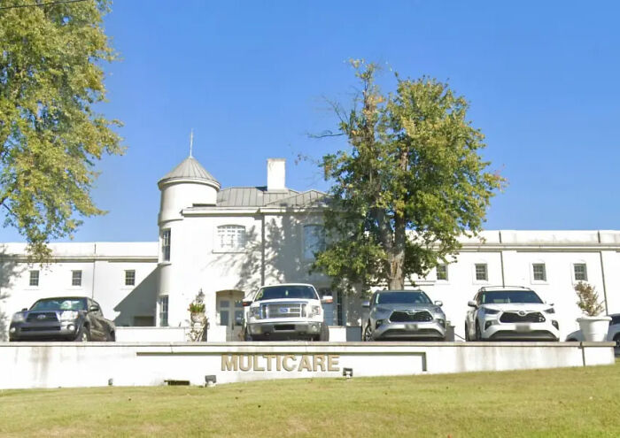 An exterior view of a multi-care building with cars parked in front, where the doctor worked before leaving the baby in a hot car. An exterior view of a multi-care building with cars parked in front, where the doctor worked before leaving the baby in a hot car.