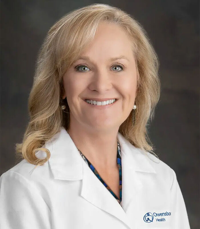 A smiling doctor in a white lab coat with blonde hair, an Owensboro Health logo on her sleeve. She forgot the baby in a hot car. A smiling doctor in a white lab coat with blonde hair, an Owensboro Health logo on her sleeve. She forgot the baby in a hot car.