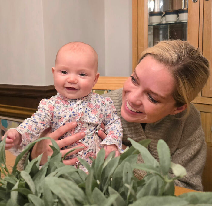 A smiling baby being held by an adult, symbolizing the joy and responsibility of caring for a baby. A smiling baby being held by an adult, symbolizing the joy and responsibility of caring for a baby.